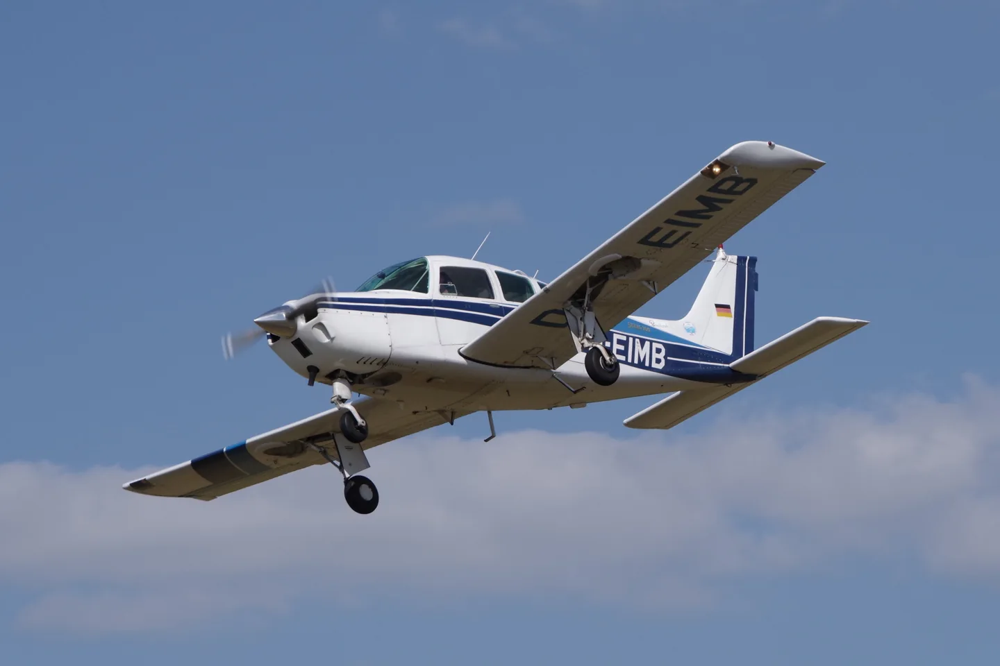 Beechcraft C24R Sierra D-EIMB in flight, with its landing gear extended.