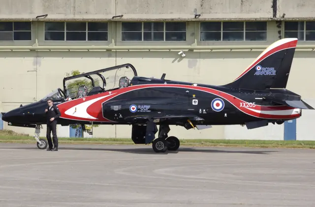 A Royal Air Force Hawk T1A at Kemble Airport , Gloucestershire, with its pilot