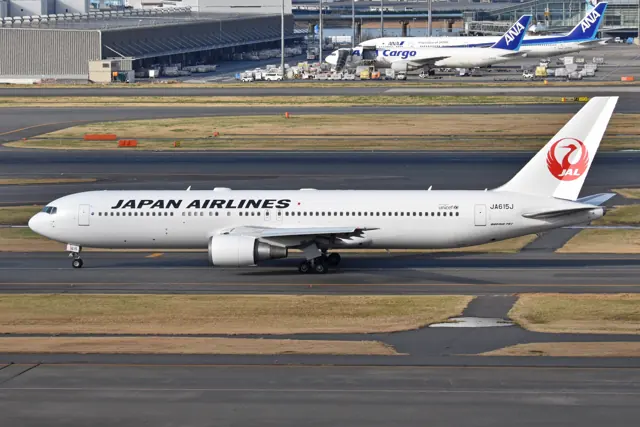 Side view of a Japan Airlines 767-300ER, with GE CF6 engines. In the background is also a 767-300ER serving ANA Cargo , having been converted into a freighter .