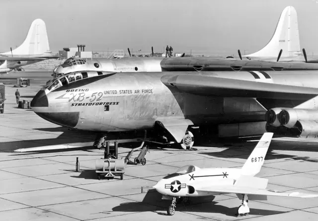 XB-52 prototype on flight line ( X-4 in foreground; B-36 behind). Note original tandem-seat " bubble " style canopy, similar to Boeing's earlier B-47 Stratojet .