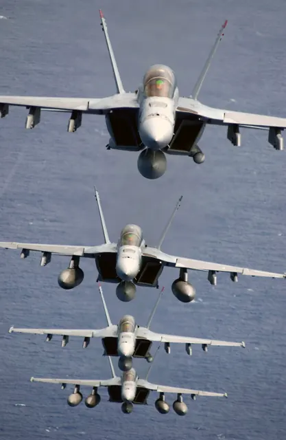 Four F/A-18Fs of VFA-41 "Black Aces" in a trail formation. The first and third aircraft have AN/ASQ-228 ATFLIR pods, and the last aircraft has a buddy store tank