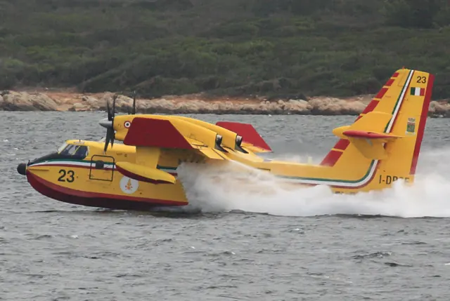 Italian Vigili del Fuoco refilling near Alghero , spilling excess water through underwing overflow ports