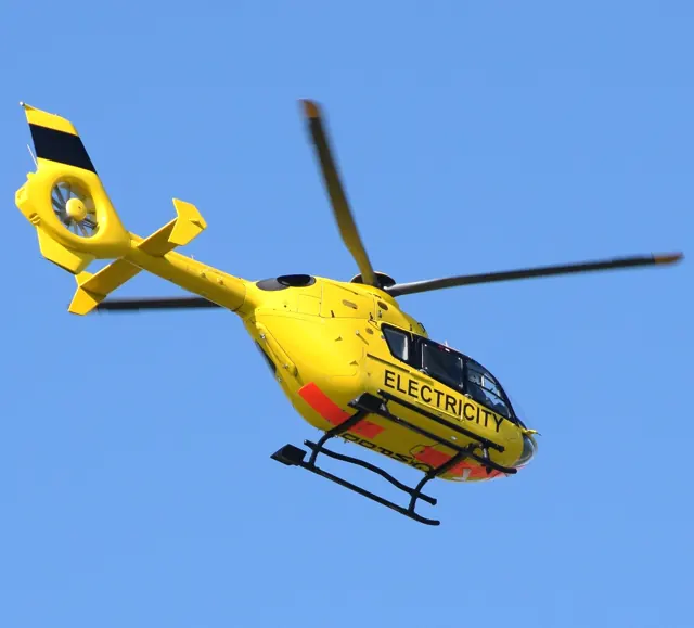 A EC135P1 of Western Power Distribution leaves Bristol Airport , 2016