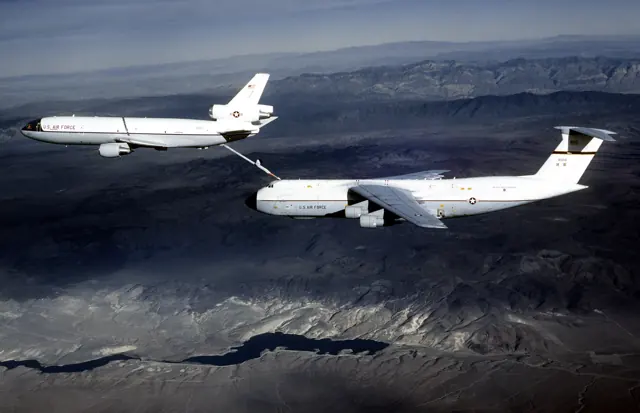 An early KC-10 Extender aircraft refuels a C-5 Galaxy in 1980. Both aircraft are wearing liveries typical of that era.